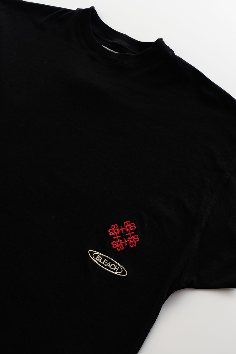 Monogram + BLEACH oval — black tee